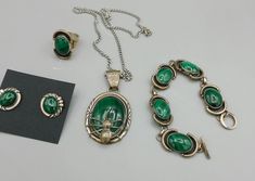 Native Navajo A.J. Singer Signed Sterling Silver 925 Malachite Stone Spider Necklace Jewelry Set Bracelet Ring and Earrings About this item Beautiful set of Malachite Jewelry with necklace, ring, bracelet, and earrings. The necklace measures 18 inches end to end and is marked sterling with the artist initials as shown . Made by Navajo artist A.J. Singer. The earrings are marked sterling, and the Bracelet measures 6 inches end to end. The pendant is 1 1/2 inches by 1 inch wide. The pendant and earrings match, the ring, and bracelet are a married set. The ring is marked sterling and I do not know the size.  Pictures do not do this set justice! The spider in Navajo tribes comes from Navajo mythology, Spider Woman is known as Na'ashjé'ii Asdzáá and is considered a powerful creator goddess who Green Sterling Silver Collectible Jewelry, Collectible Green Sterling Silver Jewelry, Navajo Mythology, Spider Necklace, Set Bracelet, Malachite Jewelry, Malachite Stone, Necklace Ring, Unisex Gift