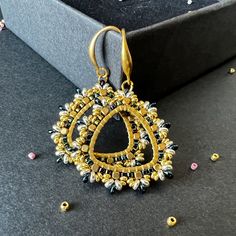 a pair of earrings sitting on top of a table