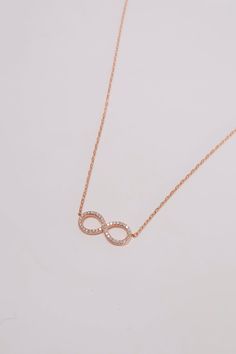 PLX501 (DS1024N) Celebrate eternal love and connection with our Handmade 14K Rose Gold Diamond Infinity Charm Necklace. This exquisite necklace features an infinity symbol charm adorned with natural diamonds, symbolizing everlasting bonds and infinite possibilities. Crafted from 14K rose gold, the necklace exudes a warm and romantic allure. The infinity charm is intricately designed, with each diamond expertly set to create a dazzling display of brilliance. The natural diamonds add a touch of sp Elegant Rose Gold Infinity Necklace, Luxury Rose Gold Infinity Jewelry, Rose Gold Infinity Necklace For Anniversary, Dainty Infinity Rose Gold Necklace, Dainty Rose Gold Infinity Necklace, Rose Gold Infinity Jewelry With Diamond Accents, Anniversary Rose Gold Necklace With Si Clarity, Infinity Necklace With Diamond Accents, Dainty Rose Gold Infinity Jewelry