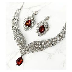 a necklace and earring set with red stones