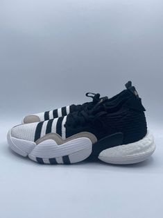 Elevate your basketball game with these Adidas Trae Young 2 sneakers. The low top shoes feature a knitted upper and rubber outsole for optimal performance on the court. They come in a stylish white and black striped pattern with lace-up closure, perfect for activewear occasions. Customized for ultimate comfort, these athletic shoes have a regular shoe width and are part of the Adidas New product line. Shoes are size 9 in US and 8.5 in UK. They are an ideal choice for any basketball enthusiast lo Low-top Basketball Shoes With Textured Sole, Adidas Sporty Sneakers With Textured Sole, Sporty White Basketball Shoes With Textured Sole, Modern Low-top Basketball Shoes With Textured Sole, Lace-up Basketball Shoes With Textured Sole For Sports, Adidas Sneakers For Basketball With Round Toe, Adidas Round Toe Basketball Sneakers, Adidas Round Toe Sneakers For Basketball, Sporty Mid-top Basketball Shoes With Textured Sole