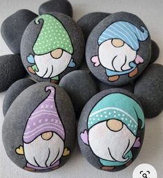 four rocks with cartoon characters painted on them