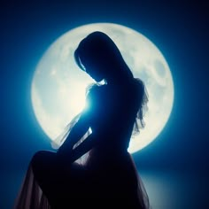 a woman sitting in front of a full moon