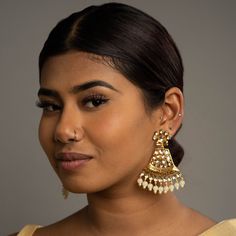 Add elegance with our White Mahila Kundan Earrings. This piece feautures high-quality Tyaani Kundan on silver foiling with an intricate Meenakari design a White crystals. Specifications Materials used: Tyaani Kundan, Silver Foiling, Gold plating, Meenakari At Romikas, we pride ourselves on the craftsmanship and high quality of our jewelry, designed to enhance your natural beauty. Please contact us with any questions. White Chandbali Fusion Earrings, Bridal Earrings For Diwali, Heavy Chandbali Pearl Earrings, Heavy Bridal Earrings For Festive Occasions, Festive Cutdana Chandelier Earrings, Silver Meenakari Chandelier Earrings For Diwali, Temple Jewelry Style Meenakari Chandelier Earrings, Elegant Silver Meenakari Danglers, Festive Silver Meenakari Chandelier Earrings