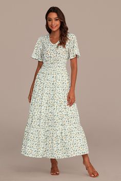 White Floral Short Sleeve V Neck Tiered Maxi Dress Modest V-neck Maxi Dress For Day Out, Flowy Floral Print V-neck Dress, Casual V-neck Maxi Dress With Ditsy Floral Print, Modest V-neck Floral Print Dress, V-neck Sundress With Ditsy Floral Print, Ditsy Floral Print V-neck Sundress, Casual V-neck Flowy Maxi Dress, Feminine Flowy Skirt Maxi Dress With V-neck, Modest V-neck Spring Dresses