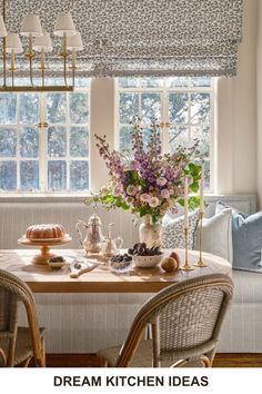 a dining room table with flowers on it