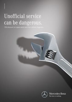 an advertisement for mercedes with a wrench in the shape of a dinosaur