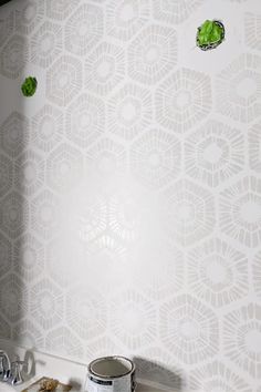 a bathroom wall with green leaves painted on it