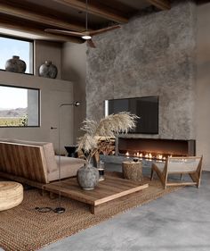 a living room filled with furniture and a flat screen tv mounted to the wall next to a fire place