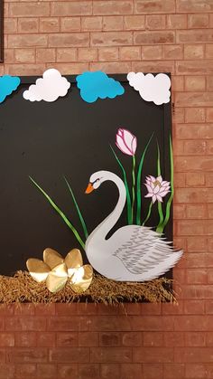 a painting of a swan and flowers on a brick wall