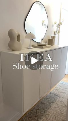 an ikea shoe storage unit in the corner of a room with a mirror and vase on it