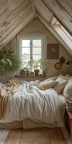 an attic bedroom with a bed, window and plants in the corner on the wall