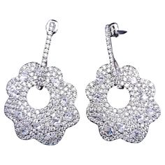 Add a touch of dazzling elegance to your jewelry collection with the Kenneth Jay Lane pave clear cubic zirconia crystal dangle floral earrings. These exquisite earrings feature a dazzling display of pave-set clear cubic zirconia crystals, meticulously arranged on a silver floral motif. The silver-tone setting enhances the brilliance of the stones, creating a radiant sparkle that catches the light with every movement! Pave Jewelry, Flower Crystal, Silver Dangle Earrings, Kenneth Jay Lane, Floral Earrings, Silver Earrings Dangle, Floral Motif, Jewelry Earrings Dangle, Cubic Zirconia