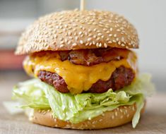 a cheeseburger with lettuce and bacon