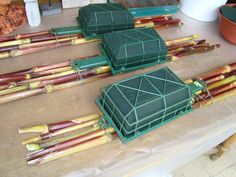 several green cages sitting on top of a wooden table