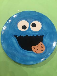 a blue plate with an image of a cookie monster holding a cookie in it's mouth