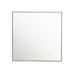 a white square mirror sitting on top of a wall