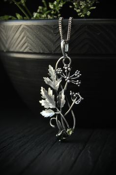 ITEM DESCRIPTION: The size H 5 cm x W 3 cm (2 x 1 1/3 inch). Weight - 5 g. You can buy it with a silver chain or without it. Even simple plants look very elegant. I made one of sterling silver, pretty green tourmaline, and peridot. This unique botanical jewelry looks like a real treasure of wild forest. It is really worthy of being in your precious collection. Expect many compliments on this! This handmade necklace will come to you in a gift box - ready for gifting. The parcel will be sent durin Nature-inspired Engraved Flower Pendant Necklace, Delicate Green Sterling Silver Necklaces, Delicate Green Sterling Silver Necklace, Green Sterling Silver Flower Pendant Jewelry, Botanical Sterling Silver Jewelry Gift, Nature-inspired Silver Metal Necklace, Silver Engraved Nature-inspired Necklace, Green Sterling Silver Necklace With Flower Pendant, Nature-inspired Sterling Silver Leaf Necklace