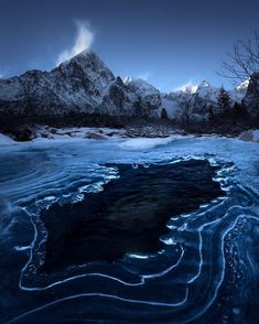 an icy river with mountains in the background