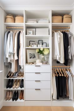 an organized closet with white shelves and drawers