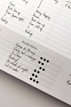 a close up of a sheet of paper with writing on it and numbers written in black ink