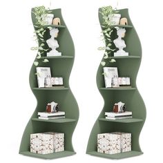 two green curved shelves with books and vases on each shelf, side by side