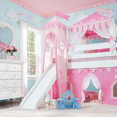 a child's bedroom with a pink princess castle bed and slide