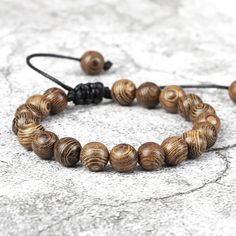 All Wooden Bracelet, Extremely Lightweight, While Bringing A Trendy, Vintage Look With It. 2 Beads On Each End Too Pull The Bracelet Together For Size Adjusting. It Is Essentially One Size Fits All Made Of Quality Wood Durable And Comfortable Too Wear. Thick Black String Too Hold It All Together That Can Handle Being Pulled And Tugged On! Buddhist, Buddhist Bracelet, Buddhist Prayer Beads, Buddhist Clothing, Tibetan Buddhist, Buddhist Beads, Buddhist Prayer Bead, Korean Buddhist, Buddhist Prayer Buddhist Clothing, Buddhist Beads, Tibetan Buddha, Buddhist Bracelet, Fish Hook Necklace, Buddha Bracelets, Hook Necklace, Buddhist Prayer, Meditation Bracelet