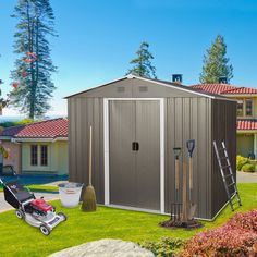 a garden shed with tools in the grass and landscaping equipment outside on the lawn next to it