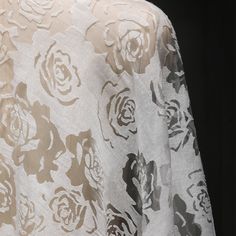 an image of a white and black flowered cloth on a mannequin head