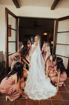 the bride is getting ready to walk down the aisle with her bridesmaids in pink dresses