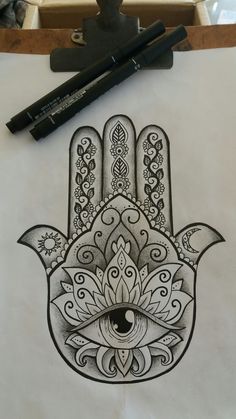 a drawing of a hamsa on paper