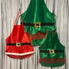 two christmas aprons with santa hats on them