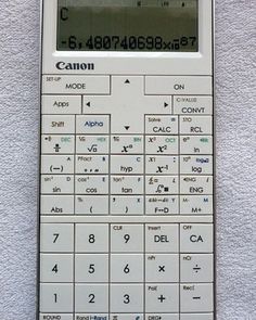 a calculator sitting on top of a white wall