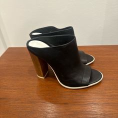 New. Never Worn With Price Tag. Soft Leather With Wooden Heel. $80 Or Best Offer. Black Leather Mules With Sculpted Heel, Black Mules With Contrasting Heel Counter, Black Leather Mules With Contrasting Heel, Black Open Heel Mules With Contrasting Heel Counter, Black Leather Mules With Stacked Heel, Casual Leather Heels With 4-inch Heel, Designer Black Mules With Sculpted Heel, Trendy Leather Heels With Contrasting Heel Counter, Black Mules With Wooden Heel For Spring