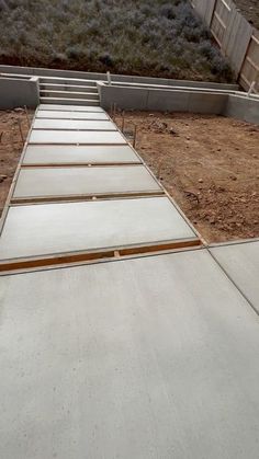 a concrete walkway is being built in the yard