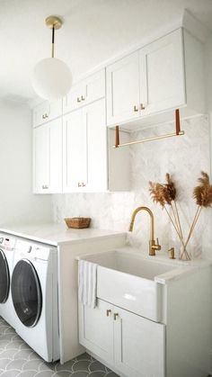 a washer and dryer in a white kitchen