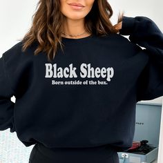 Embrace your uniqueness with our 'Black Sheep, Born Outside' sweatshirt--a bold declaration of individuality. Crafted with comfort and style, this sweatshirt is perfect for those who march to the beat of their own drum. Whether you've always felt like the odd one out or simply revel in being different, this sweatshirt is a tribute to your authenticity. Stand out from the crowd and celebrate your outsider status with pride! **Remember, SIZE UP for the oversized sweater look.  See size chart for r Black Band Merch Sweater For Fall, Black Band Merch Sweatshirt With Slogan, Black Fleece Sweater With Letter Print, Black Slogan Sweatshirt Crew Neck, Black Crew Neck Sweatshirt Band Merch, Black Winter Slogan Sweater, Black Slogan Sweater For Winter, Black Slogan Crew Neck Sweater, Black Crew Neck Sweater With Slogan