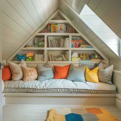 a room with some bookshelves and pillows on it