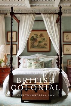 a canopy bed with white drapes and pillows in a blue room that says british colonial