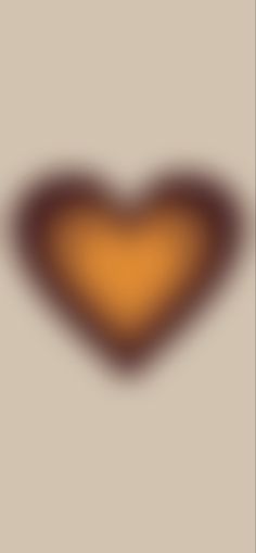 an orange and brown heart shaped object on a gray background