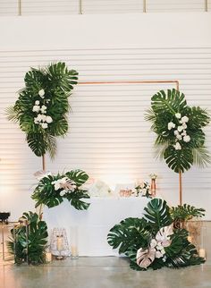 the table is set up with greenery and flowers