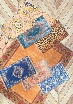 an assortment of rugs laid out on top of each other in different colors and patterns