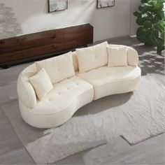 a white couch sitting on top of a rug in a living room