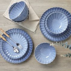 blue dishes and utensils on a wooden table