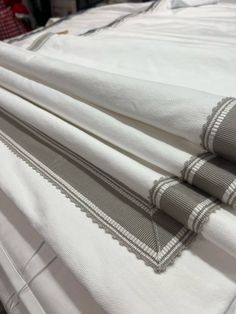 three folded sheets with white and grey checkered trims on each side, sitting next to one another