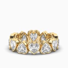 a yellow gold ring with heart shaped diamonds