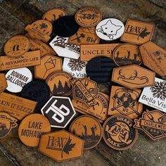 a pile of wooden badges sitting on top of a table