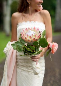 a bride holding a bouquet of flowers in her hand