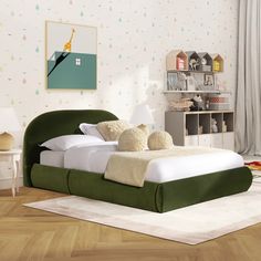 a green bed with two pillows on top of it in front of a white rug